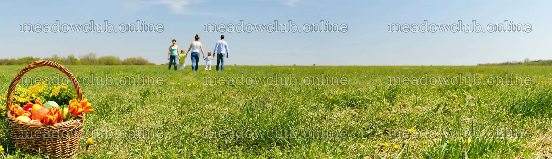 Easter basket in a meadow with people walking in the distance – meadow photos 14762x4268
