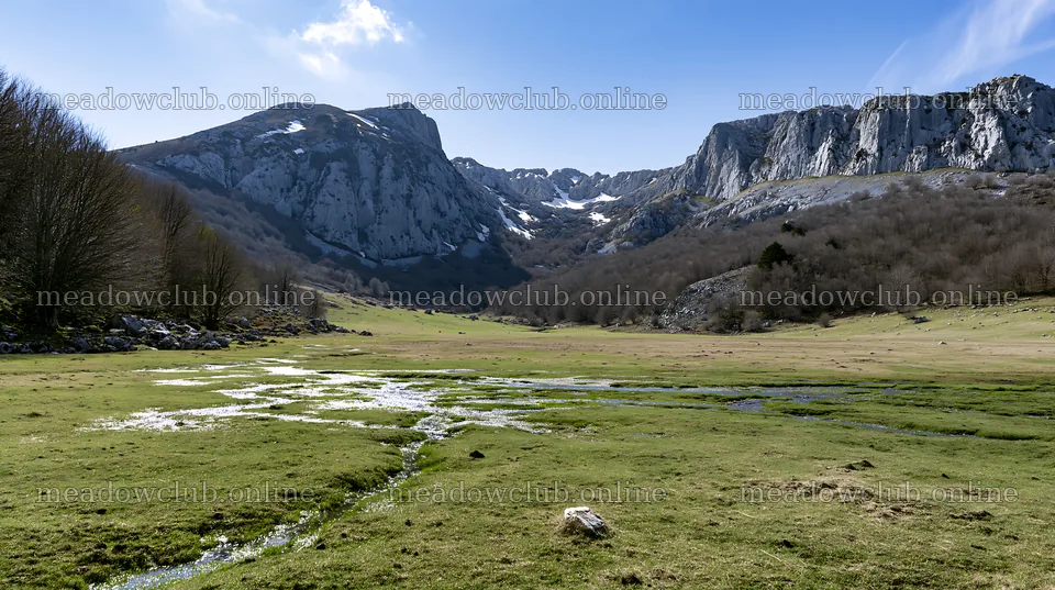 Meadow located beneath crags with stream flowing through it – meadow photos 10608x5938