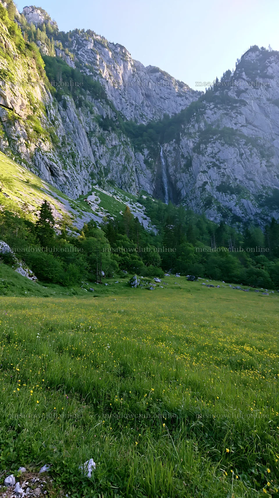 Meadow beneath crags with steep mountains and waterfall – meadow photos 5938x10608